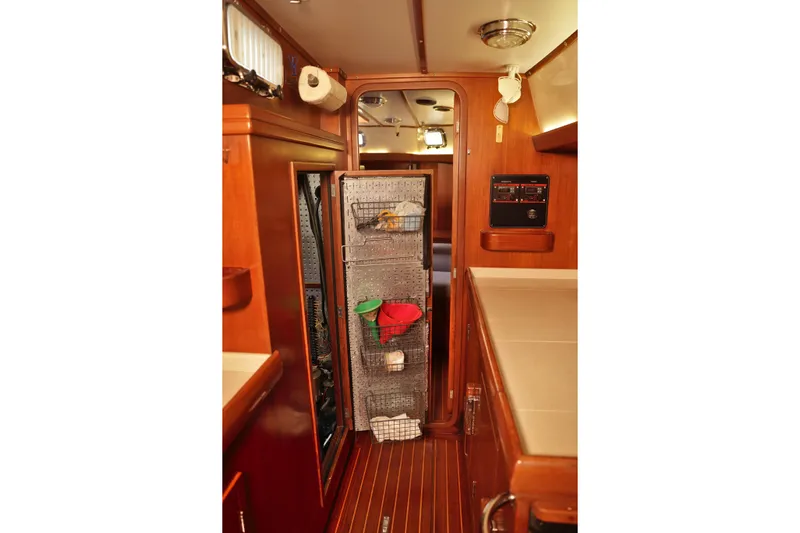 Oleta Yacht Photos Pics Interior of 2005 Tayana 48 yacht with wooden cabinetry and storage area.