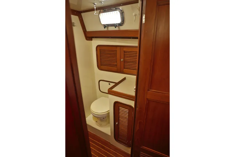 Oleta Yacht Photos Pics 2005 Tayana 48 yacht bathroom with wooden cabinetry and compact design.