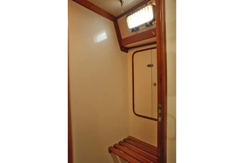 Oleta Yacht Photos Pics Interior of 2005 Tayana 48 sailboat with wooden accents and a small window.