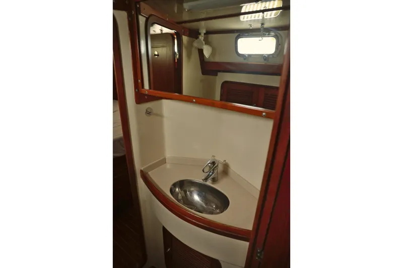 Oleta Yacht Photos Pics Bathroom sink area in 2005 Tayana 48 yacht with wooden accents and mirror.