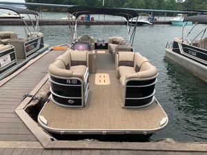 2021 G3 SunCatcher Fusion 325RCX pontoon boat docked at a marina.