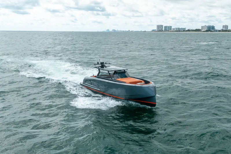 Pharmasea Yacht Photos Pics 2022 Vanquish Yachts VQ45 cruising on open water with city skyline in background.
