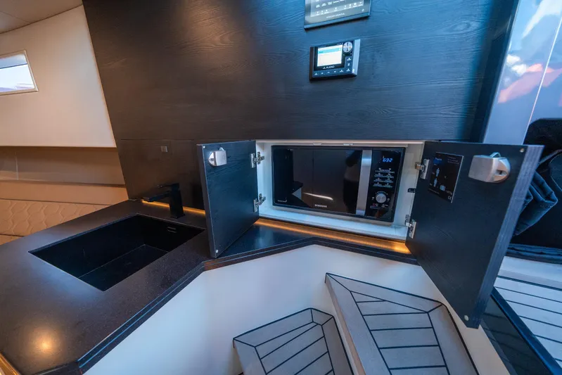 Pharmasea Yacht Photos Pics Modern kitchen area in 2022 Vanquish Yachts VQ45 with microwave and sleek design.