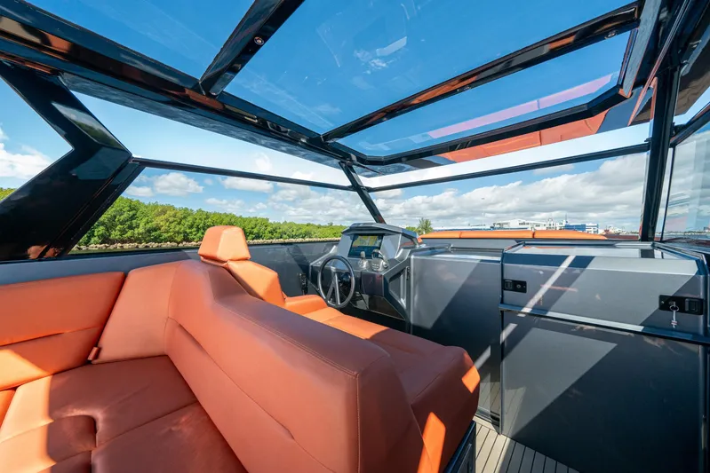Pharmasea Yacht Photos Pics Luxurious 2022 Vanquish Yachts VQ45 interior with orange seating and panoramic views.