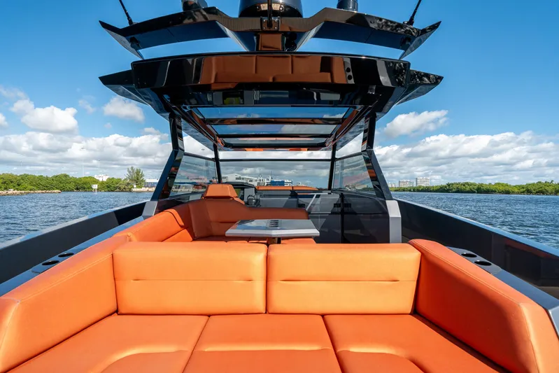 Pharmasea Yacht Photos Pics Luxurious 2022 Vanquish Yachts VQ45 with orange seating, cruising on a sunny day.
