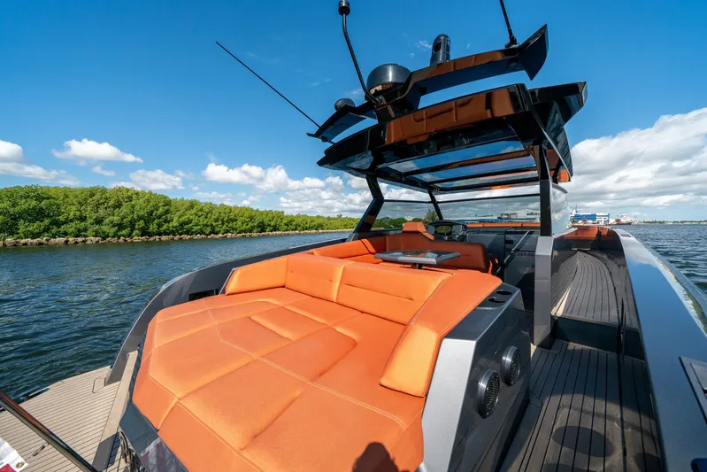 Pharmasea Yacht Photos Pics 2022 Vanquish Yachts VQ45 with orange seating, sleek design, on a sunny day.