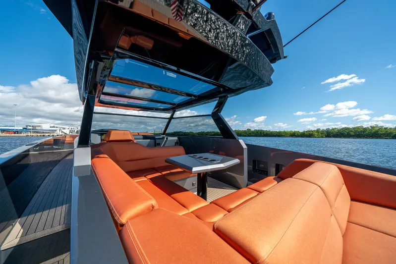 Pharmasea Yacht Photos Pics 2022 Vanquish Yachts VQ45 with orange seating, sleek design, and open water view.