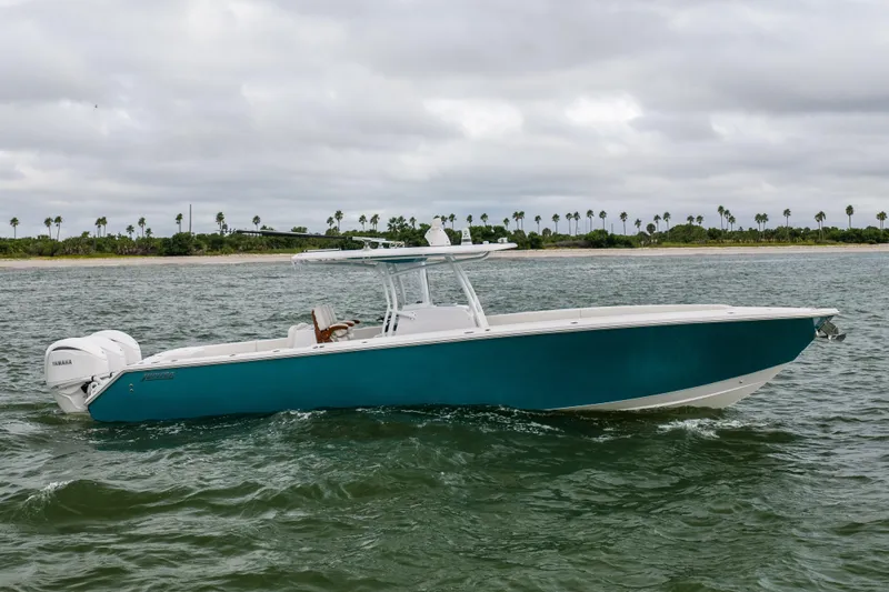 Yacht Photos Pics 2022 Jupiter 38 HFS boat cruising on water with palm trees in background.