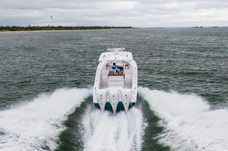  Yacht Photos Pics 2022 Jupiter 38 HFS boat cruising on open water, creating a dynamic wake.