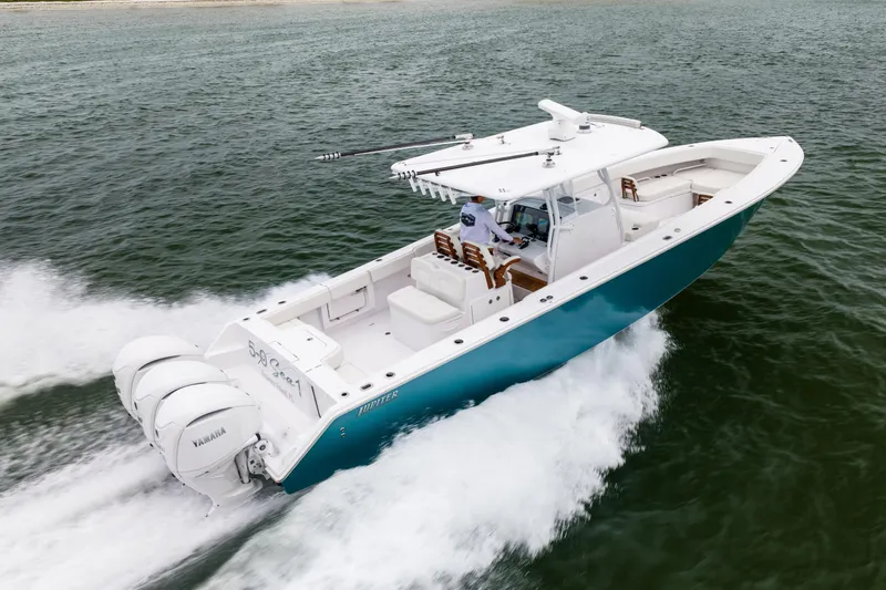  Yacht Photos Pics 2022 Jupiter 38 HFS boat cruising on water with triple Yamaha engines.