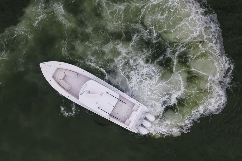  Yacht Photos Pics Aerial view of 2022 Jupiter 38 HFS boat navigating through swirling water.