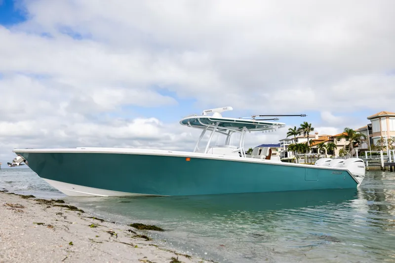  Yacht Photos Pics 2022 Jupiter 38 HFS boat docked by the shore under a cloudy sky.
