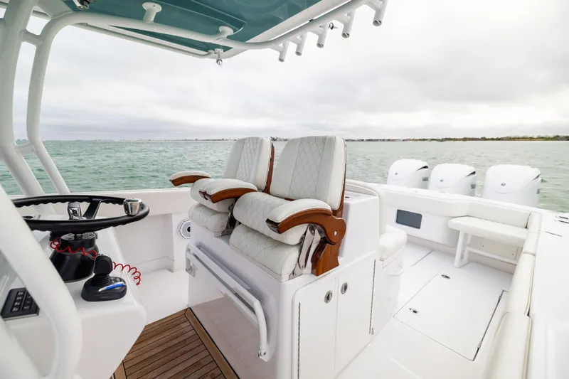  Yacht Photos Pics 2022 Jupiter 38 HFS boat interior with helm and seating, on open water.