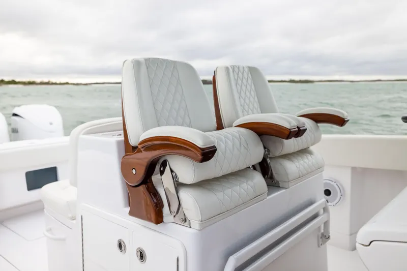  Yacht Photos Pics Luxurious seating on 2022 Jupiter 38 HFS boat with quilted upholstery and wooden armrests.