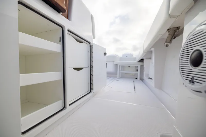  Yacht Photos Pics 2022 Jupiter 38 HFS boat interior with storage compartments and speaker.
