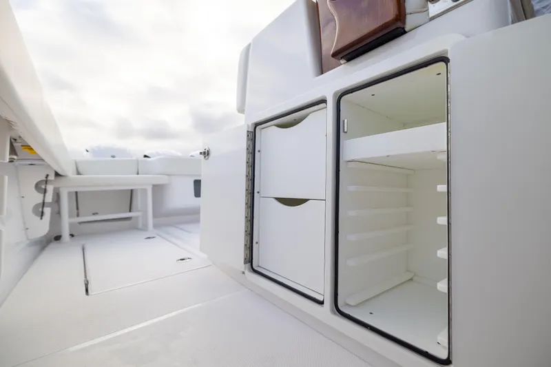  Yacht Photos Pics 2022 Jupiter 38 HFS boat interior with open storage compartments and seating area.