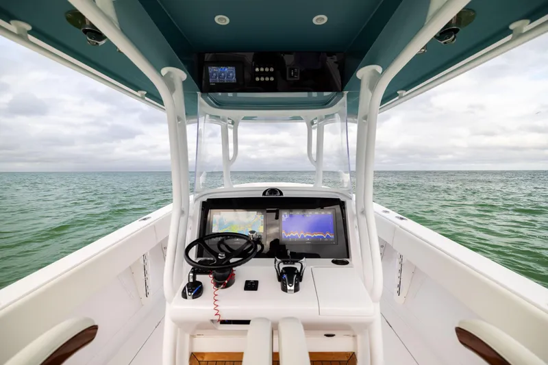  Yacht Photos Pics 2022 Jupiter 38 HFS boat helm with navigation screens on open water.