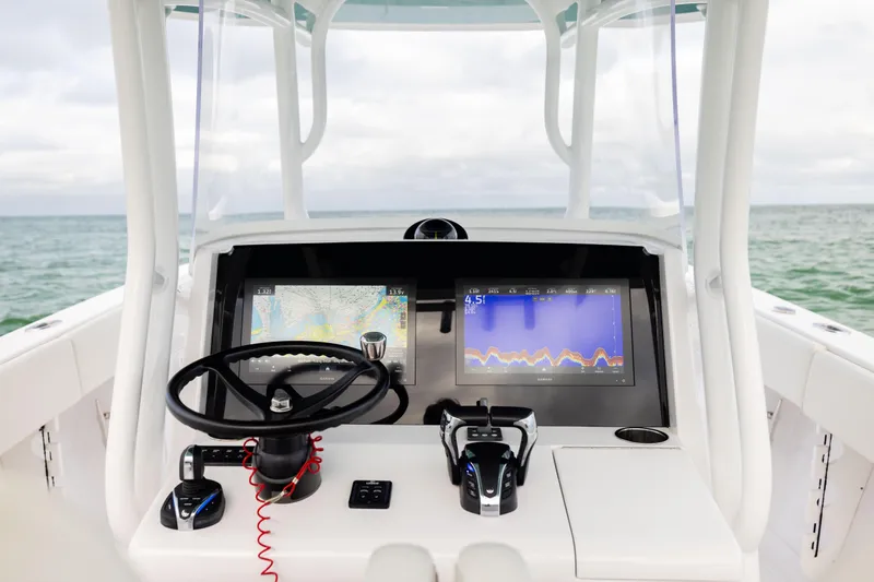  Yacht Photos Pics 2022 Jupiter 38 HFS boat helm with advanced navigation displays on open water.