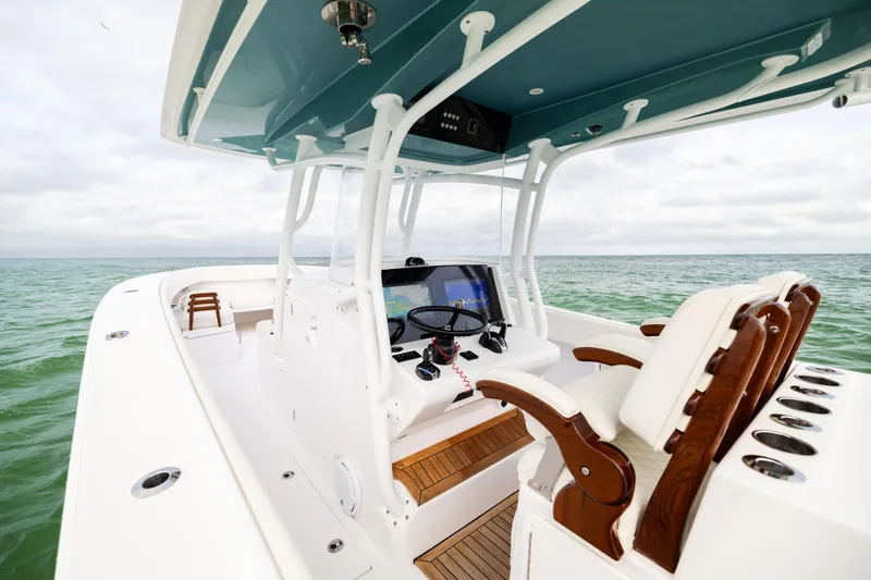 Yacht Photos Pics 2022 Jupiter 38 HFS boat interior with helm, luxurious seating, and ocean view.