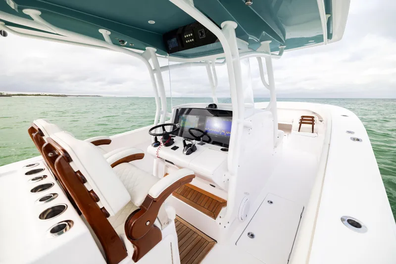  Yacht Photos Pics 2022 Jupiter 38 HFS boat interior with helm, seats, and ocean view.