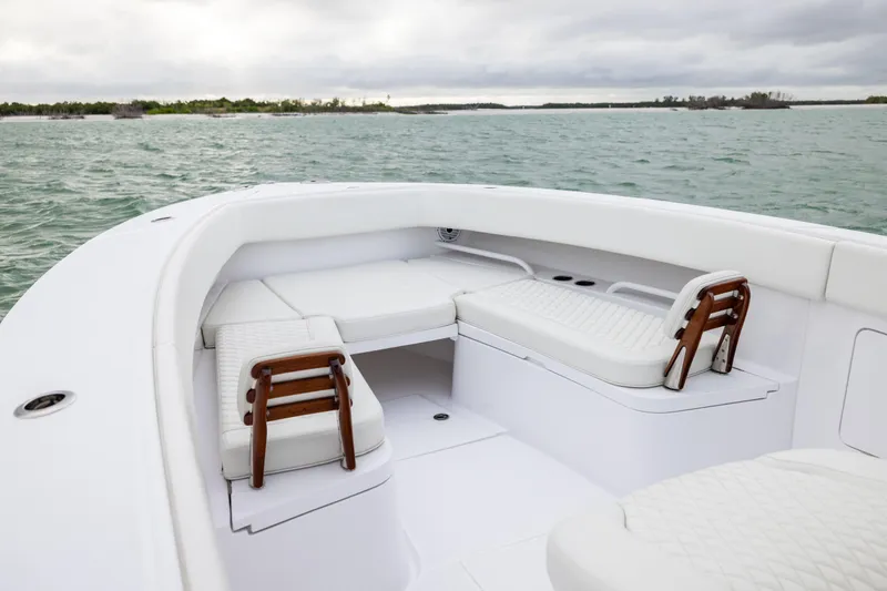  Yacht Photos Pics 2022 Jupiter 38 HFS boat interior with white seating, on calm waters.