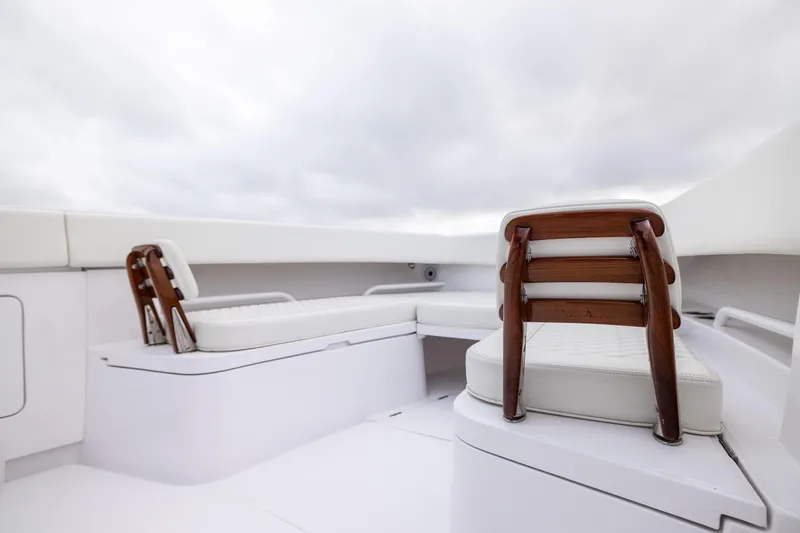  Yacht Photos Pics 2022 Jupiter 38 HFS boat interior with white cushioned seating and wooden accents.