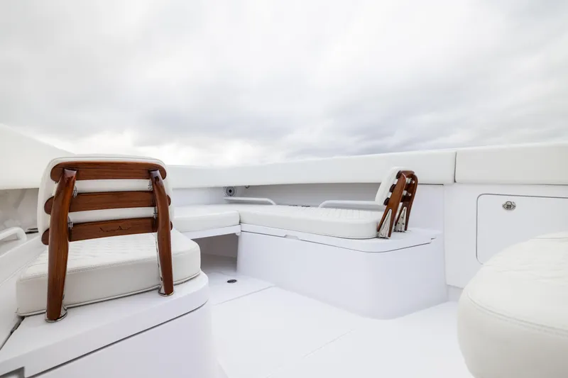  Yacht Photos Pics Luxurious seating on 2022 Jupiter 38 HFS boat, featuring elegant wooden accents and white cushions.