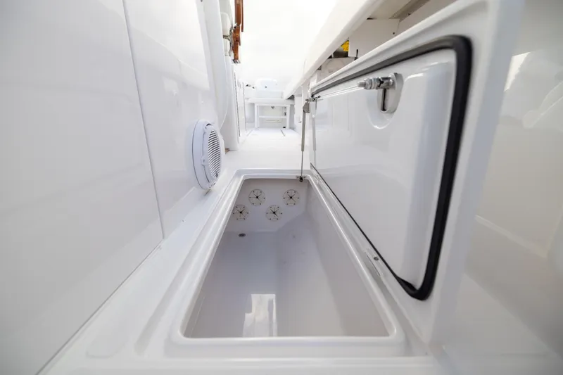  Yacht Photos Pics 2022 Jupiter 38 HFS boat storage compartment with open hatch and sleek white interior.
