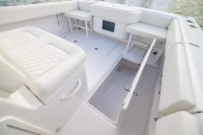  Yacht Photos Pics Luxurious 2022 Jupiter 38 HFS boat interior with white cushioned seating and storage compartments.