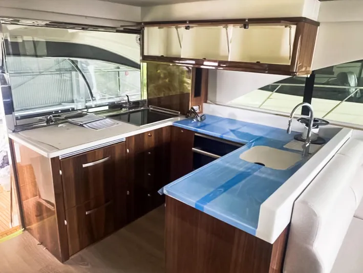  Yacht Photos Pics Luxurious kitchen interior of 2023 Riviera 57 Enclosed Flybridge yacht with modern amenities.