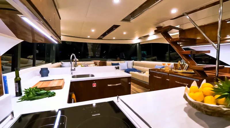  Yacht Photos Pics Luxurious interior of 2023 Riviera 57 Enclosed Flybridge yacht with modern kitchen and seating area.