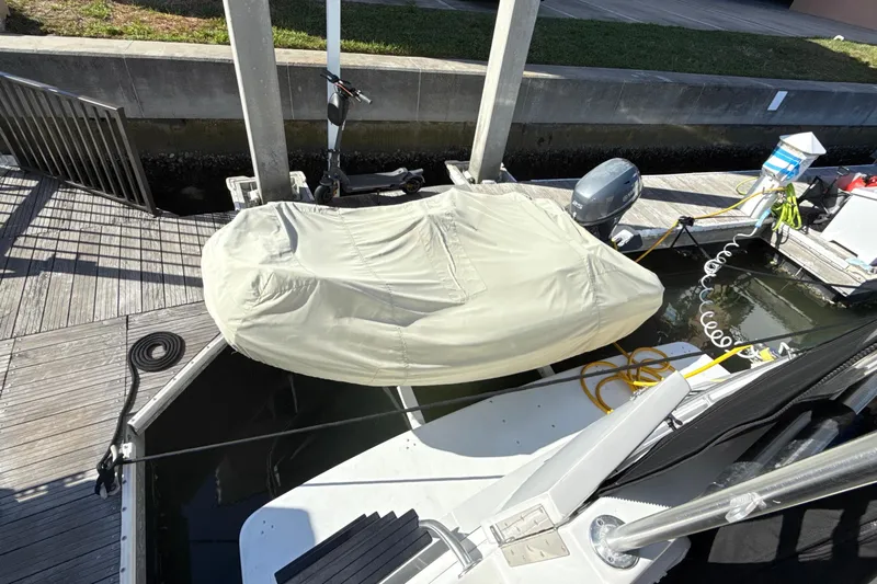 Cole-lateral Damage Yacht Photos Pics 1998 Mainship 47 Motor Yacht docked with covered equipment and coiled cables.