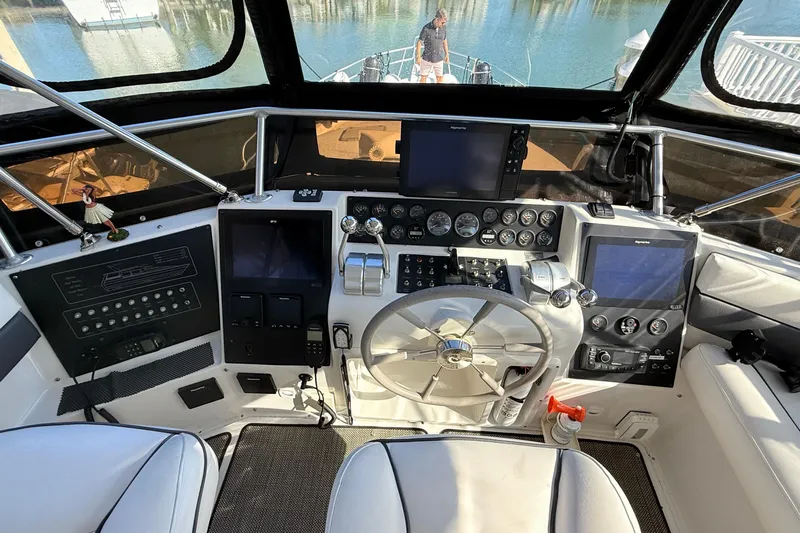 Cole-lateral Damage Yacht Photos Pics 1998 Mainship 47 Motor Yacht helm with navigation instruments and steering wheel.