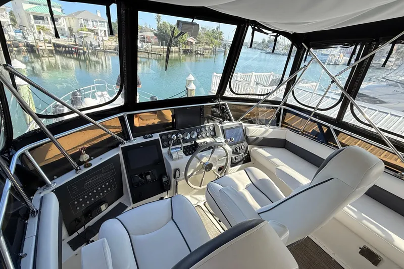 Cole-lateral Damage Yacht Photos Pics 1998 Mainship 47 Motor Yacht helm with modern controls, overlooking marina.