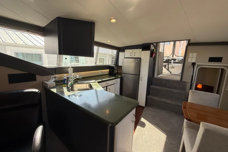 Cole-lateral Damage Yacht Photos Pics Interior of 1998 Mainship 47 Motor Yacht with modern kitchen and dining area.