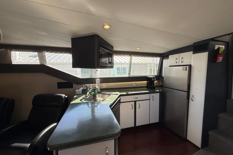 Cole-lateral Damage Yacht Photos Pics Interior of 1998 Mainship 47 Motor Yacht kitchen with modern appliances and sleek design.