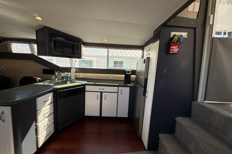 Cole-lateral Damage Yacht Photos Pics Interior of 1998 Mainship 47 Motor Yacht kitchen with modern appliances and wood flooring.