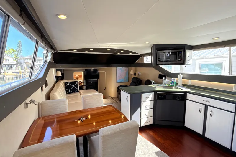 Cole-lateral Damage Yacht Photos Pics Interior of 1998 Mainship 47 Motor Yacht with modern kitchen and seating area.