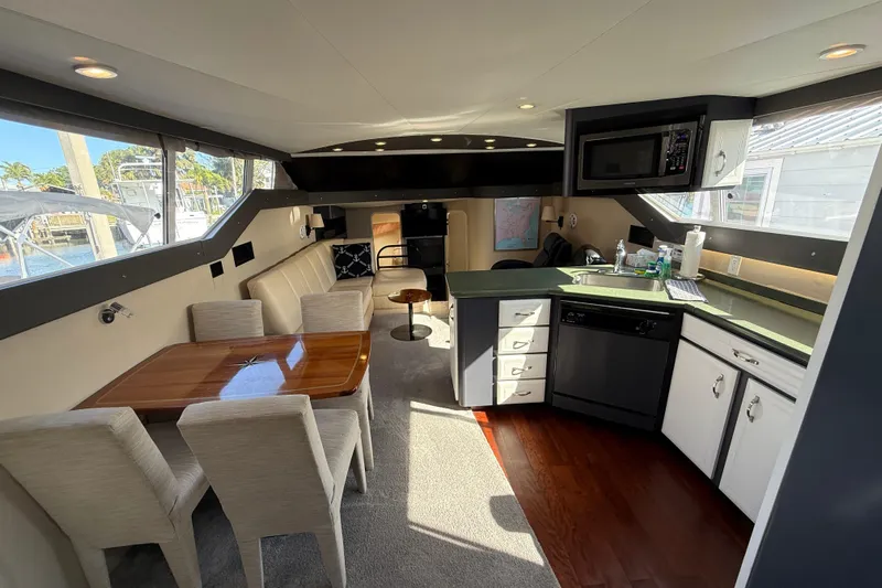 Cole-lateral Damage Yacht Photos Pics Luxurious interior of 1998 Mainship 47 Motor Yacht with dining area and modern kitchen amenities.