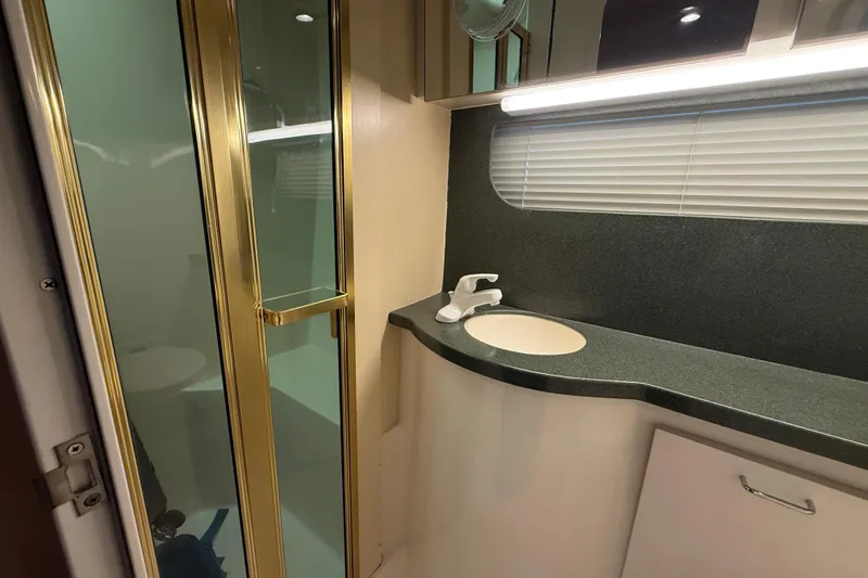 Cole-lateral Damage Yacht Photos Pics Bathroom interior of 1998 Mainship 47 Motor Yacht with shower and sink.