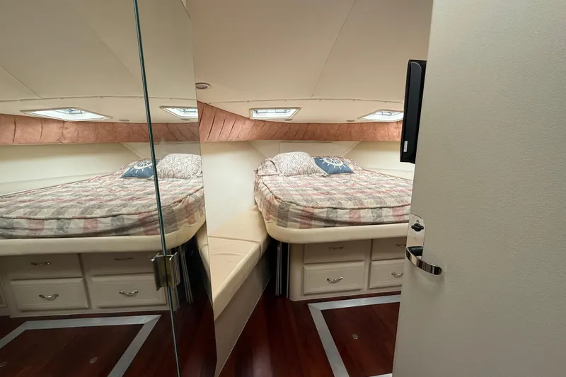 Cole-lateral Damage Yacht Photos Pics 1998 Mainship 47 Motor Yacht bedroom with cozy bed and storage drawers.