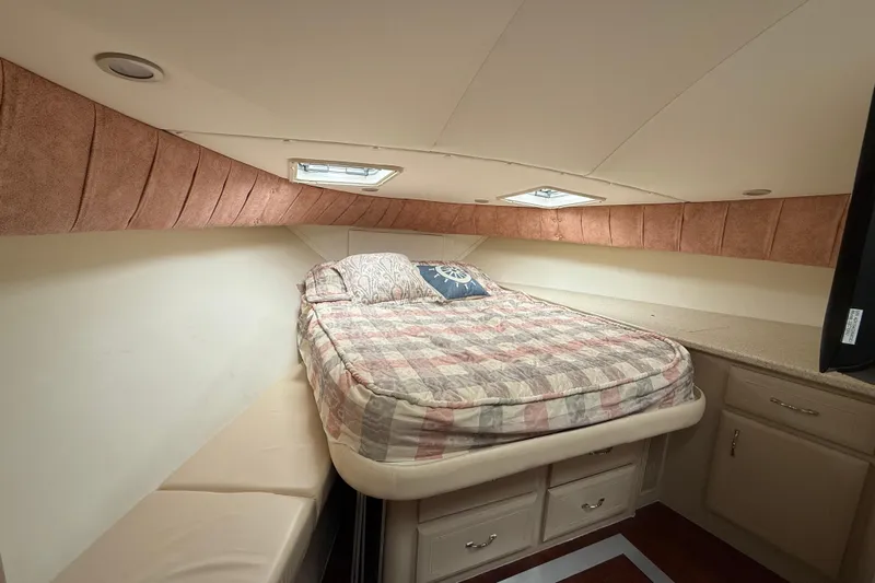 Cole-lateral Damage Yacht Photos Pics Cozy bedroom in 1998 Mainship 47 Motor Yacht with bed, storage, and natural light.