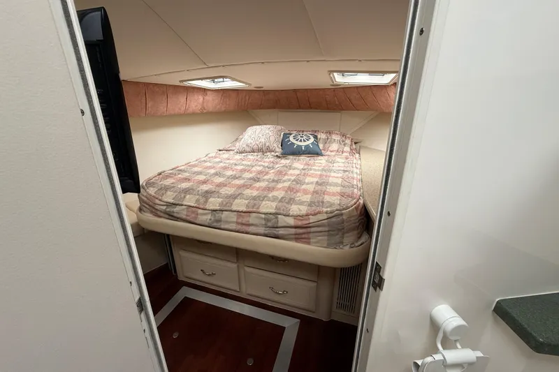 Cole-lateral Damage Yacht Photos Pics Cozy bedroom in 1998 Mainship 47 Motor Yacht with plaid bedding and nautical decor.