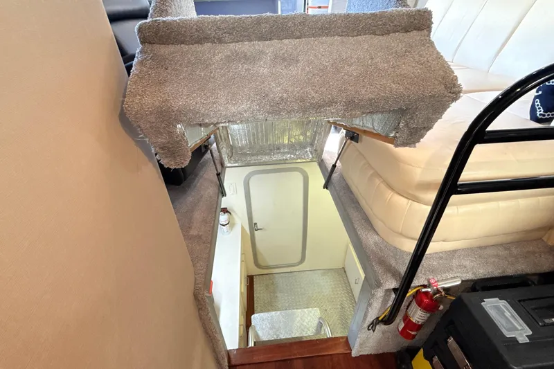 Cole-lateral Damage Yacht Photos Pics Interior view of 1998 Mainship 47 Motor Yacht, featuring stairs and cozy seating area.