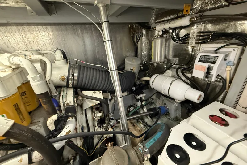 Cole-lateral Damage Yacht Photos Pics Engine room of 1998 Mainship 47 Motor Yacht with visible mechanical components.