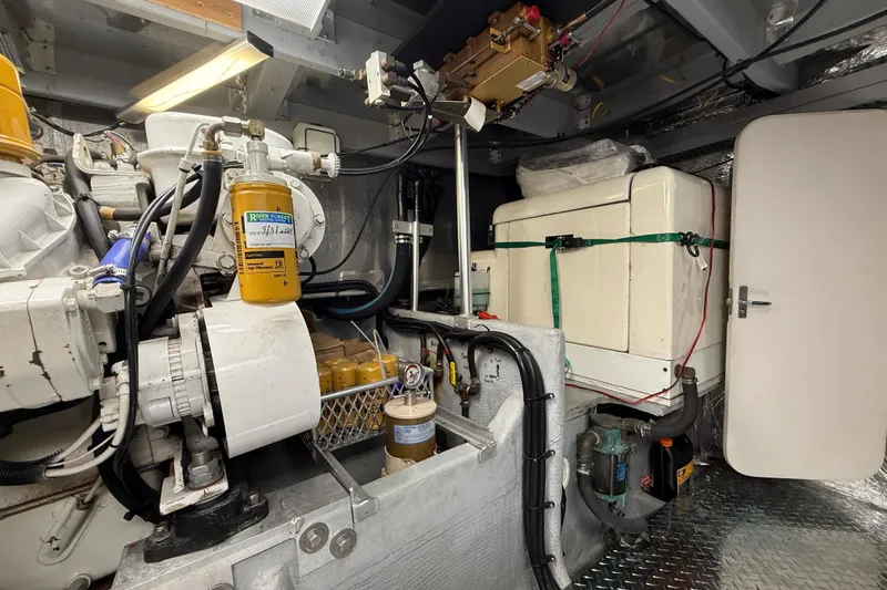 Cole-lateral Damage Yacht Photos Pics Engine room of 1998 Mainship 47 Motor Yacht with mechanical components and equipment.