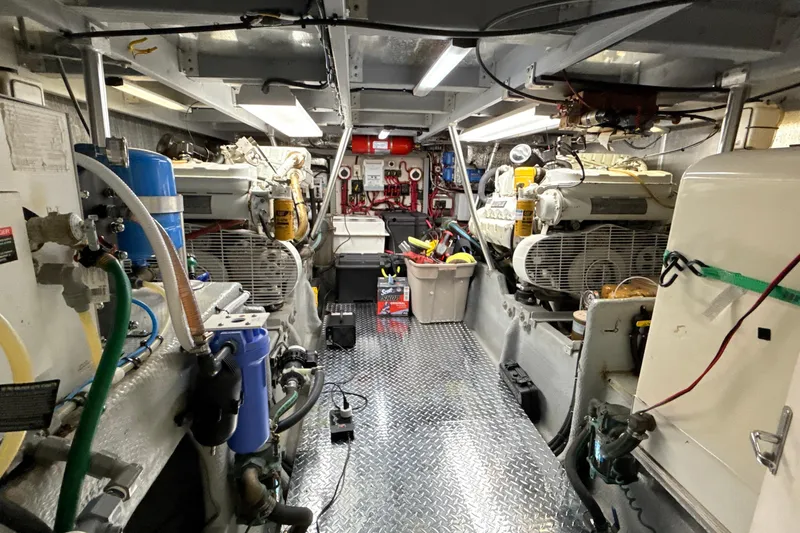 Cole-lateral Damage Yacht Photos Pics Engine room of a 1998 Mainship 47 Motor Yacht, featuring equipment and tools.