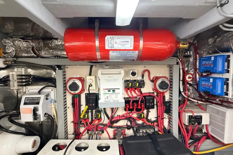 Cole-lateral Damage Yacht Photos Pics Engine room of 1998 Mainship 47 Motor Yacht with electrical systems and fire extinguisher.