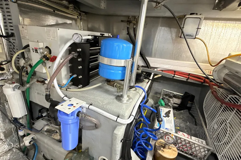 Cole-lateral Damage Yacht Photos Pics Engine room of a 1998 Mainship 47 Motor Yacht with various mechanical components.