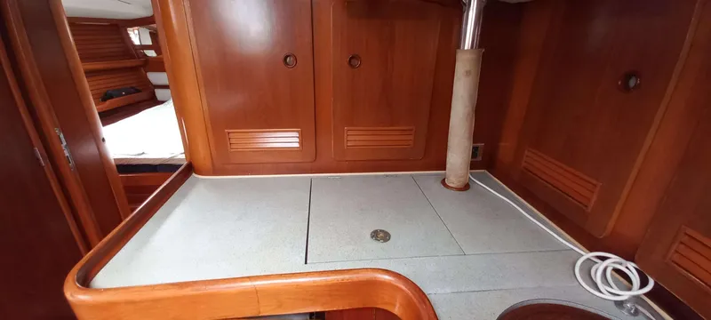 Roxanne Yacht Photos Pics Interior of 1990 Beneteau Oceanis Clipper 500 yacht with wooden cabinetry and countertop.